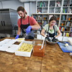 Two people cooking in a kitchen