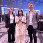 Founder Rashmi standing with her trophy from the awards.